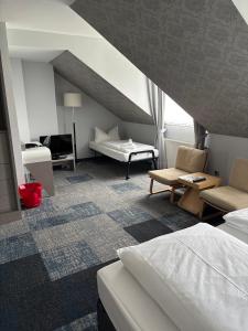 a hotel room with a bed and a couch at Hotel Flandrischer Hof in Cologne
