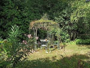 a gazebo with a table and chairs in a garden at Chateau de Coubloust in Vicq-sur-Nahon