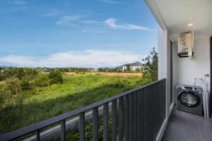 a balcony with a view of a field at Bellevue Lagoon Premium Apart Hotel by TropicLook in Laguna Phuket