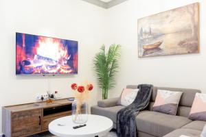 a living room with a couch and a fire at Cosy 1 Bedroom in CBD Mombasa with City View in Mombasa