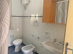 a small bathroom with a toilet and a sink at La Quercia in San Benedetto Val di Sambro +36 photos