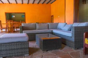 a living room with a couch and a table at Oxpecker Safari Lodge 