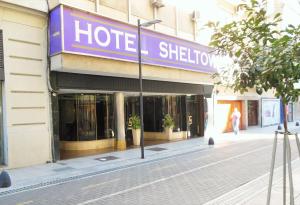 a hotel with a sign on the side of a street at Hotel Sheltown in Buenos Aires