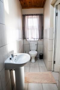 a bathroom with a toilet and a sink at Kariega Apartments - 4 Graaff-Reinet Rd in Uitenhage