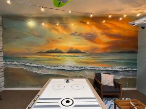 a room with a painting of the ocean at Wildlife Themed 4 Bd Pool Home Near Disney in Davenport