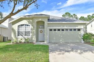 a white house with a garage at Wildlife Themed 4 Bd Pool Home Near Disney in Davenport