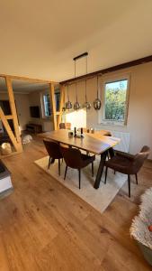 a dining room with a wooden table and chairs at Ferienhaus am Schluchtensteig 