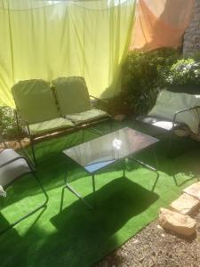 a living room with a couch and a glass table at Villa Verde Apartments and Rooms in Premantura