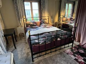 a bedroom with a bed and a table and window at Rosendala long stay by House Viola, 3 bedroom entire house in Bodafors, sleeps 7 in Bodafors