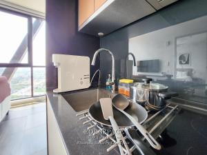 a kitchen with a sink and a counter top at Scarletz Suites by Edenzpace @ KLCC Area in Kuala Lumpur