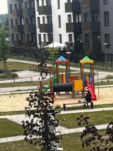 a park with a playground with colorful play equipment at Apartament Bajka nad Jeziorem in Nysa