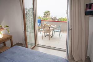 a bedroom with a balcony with a table and chairs at SulMare Alba Adriatica in Alba Adriatica