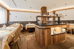 a restaurant with two tables and a counter at Chalet Ciasa Alexander in San Cassiano