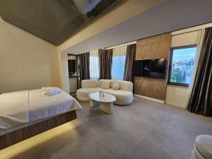 a hotel room with a bed and a couch at Sulara Exclusıve Hotel Lounge Bistro in Antalya