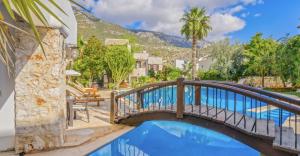 a bridge over a pool with a mountain in the background at Cozy Private House in Kadikoy in Istanbul