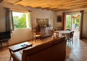 a living room with a couch and a table at Villa plain pied in Sommières
