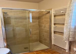 a shower with a glass door in a bathroom at Villa plain pied in Sommières