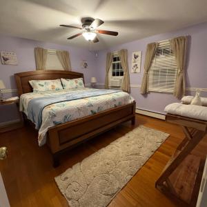 a bedroom with a bed and a ceiling fan at 5 bedroom farmhouse in sandwich cape cod in Sandwich