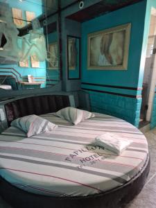a large bed in a room with blue walls at papillon hotel in São Paulo +7 photos