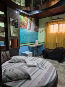 a bedroom with a large bed with a painting on the wall at papillon hotel in Sao Paulo