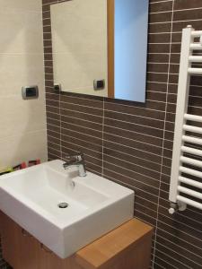 a bathroom with a white sink and a mirror at Pianeta Roma 45 in Rome +32 photos