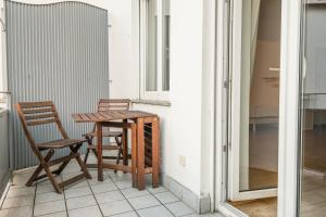 a table and two chairs on a balcony at Mainhatten Apartment in Frankfurt/Main