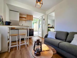 a living room with a couch and a table at L'Antre du Pin in Lourdes