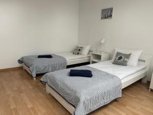 a room with two beds and a couch at Pokoje w Pucku in Puck