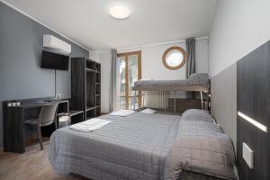 a bedroom with a bed and a desk with a desk at Urban Hotel in Cesena