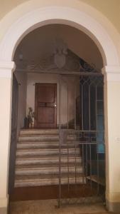 an archway with a staircase in a building at All'ombra della Torre only Rooms in Siena