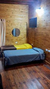 a bedroom with a bed in a wooden wall at ELLA CON El MAR in Mar del Plata
