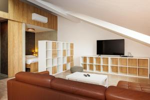 a living room with a couch and a tv at Entrez Apartments Baštová - City centre in Košice