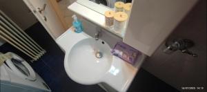 a bathroom with a white sink and a toilet at Alexandroupolis Lighthouse Apartment P!!! in Alexandroupoli +28 photos