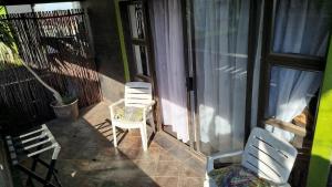 a pair of chairs sitting on a balcony at Afro Rasta Kumusha in Germiston