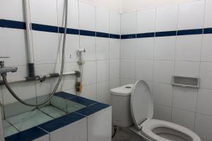 a bathroom with a toilet and a shower at Hotel Kinasih Yogyakarta in Yogyakarta +17 photos