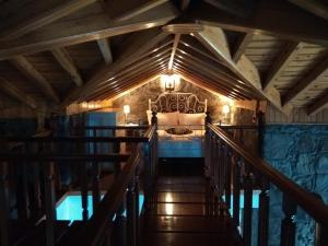 a bedroom with a bed and a staircase in a room at Moinho da Cascata in Faja Grande