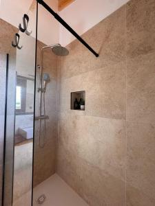 a shower with a glass door in a bathroom at Casa rural Los Acebos in La Cuesta +22 photos