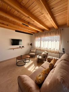 a large living room with a couch and a tv at Casa rural Los Acebos in La Cuesta