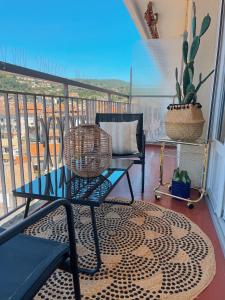 a balcony with a table and a chair on a balcony at Au 5eme ciel in Draguignan