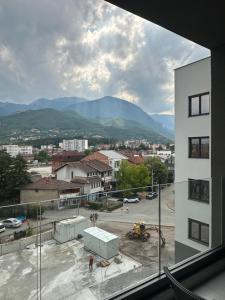 a view of a city with mountains in the background at Skyline Apartment 3 in Peje
