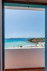a window with a view of the beach at Hotel Castello in Golfo Aranci