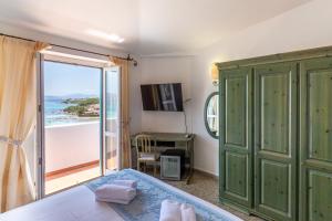 a bedroom with a bed and a view of the ocean at Hotel Castello in Golfo Aranci +37 photos
