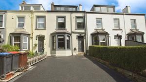a large white house with a driveway in front of it at Victoria Villas,West Cumbria, Lake District in Whitehaven
