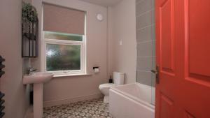 a bathroom with a sink and a toilet and a window at Victoria Villas,West Cumbria, Lake District in Whitehaven +47 photos