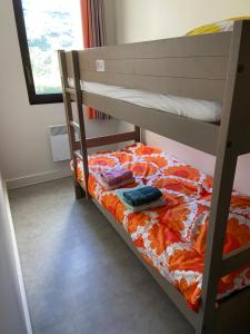 a bunk bed with two towels on top of it at Trestraou 217 in Perros-Guirec +36 photos