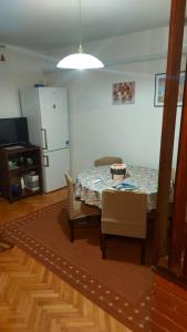 a living room with a table and chairs and a kitchen at House Lanterna Pag in Pag