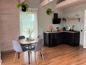 a kitchen and dining room with a table and chairs at Holiday home Filipi in Ventspils +23 photos