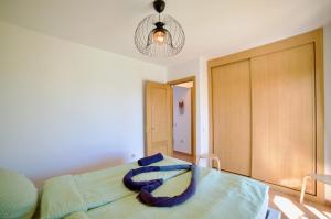 a bedroom with a bed with a towel on it at Ocean Home - No Stress Holidays in Lajares