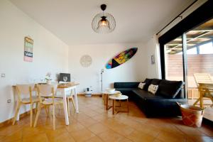 a living room with a couch and a table at Ocean Home - No Stress Holidays in Lajares