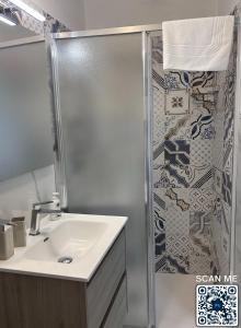 a bathroom with a sink and a shower at Affittacamere Marì in Polignano a Mare